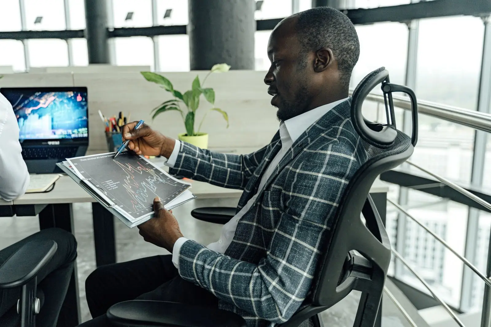 Businessman reviewing charts on a tablet in an office