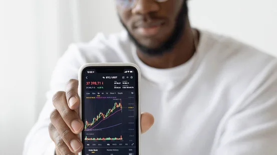 Trader checking a price chart on a smartphone